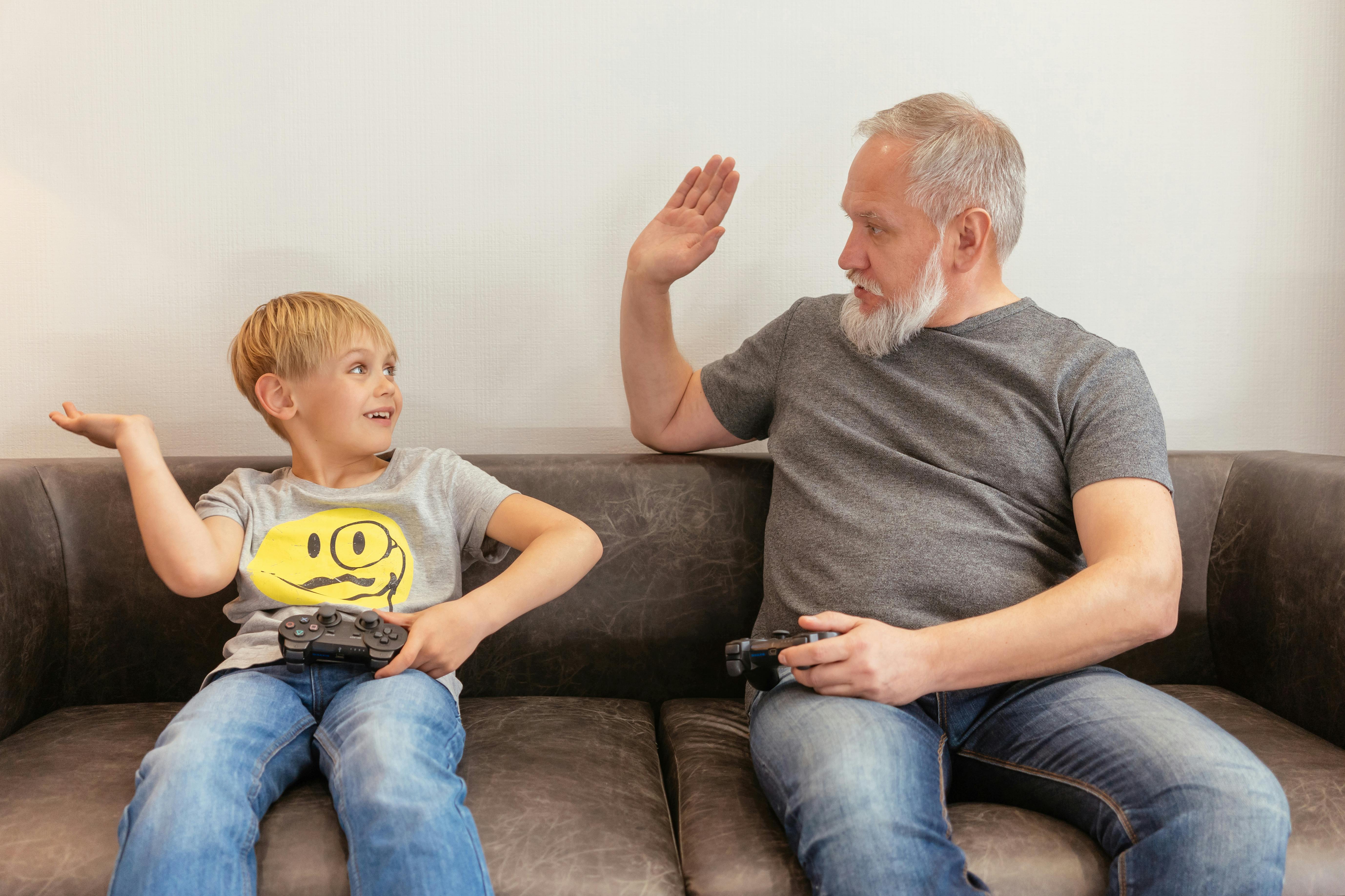 a grandfather and a boy playing console game