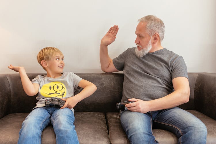 A Grandfather And A Boy Playing Console Game