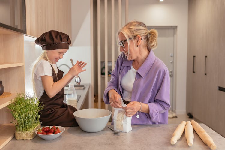 A Woman Cooking With Her Granddaughter