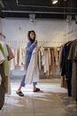 A Woman Holding a Dress at a Clothing Store