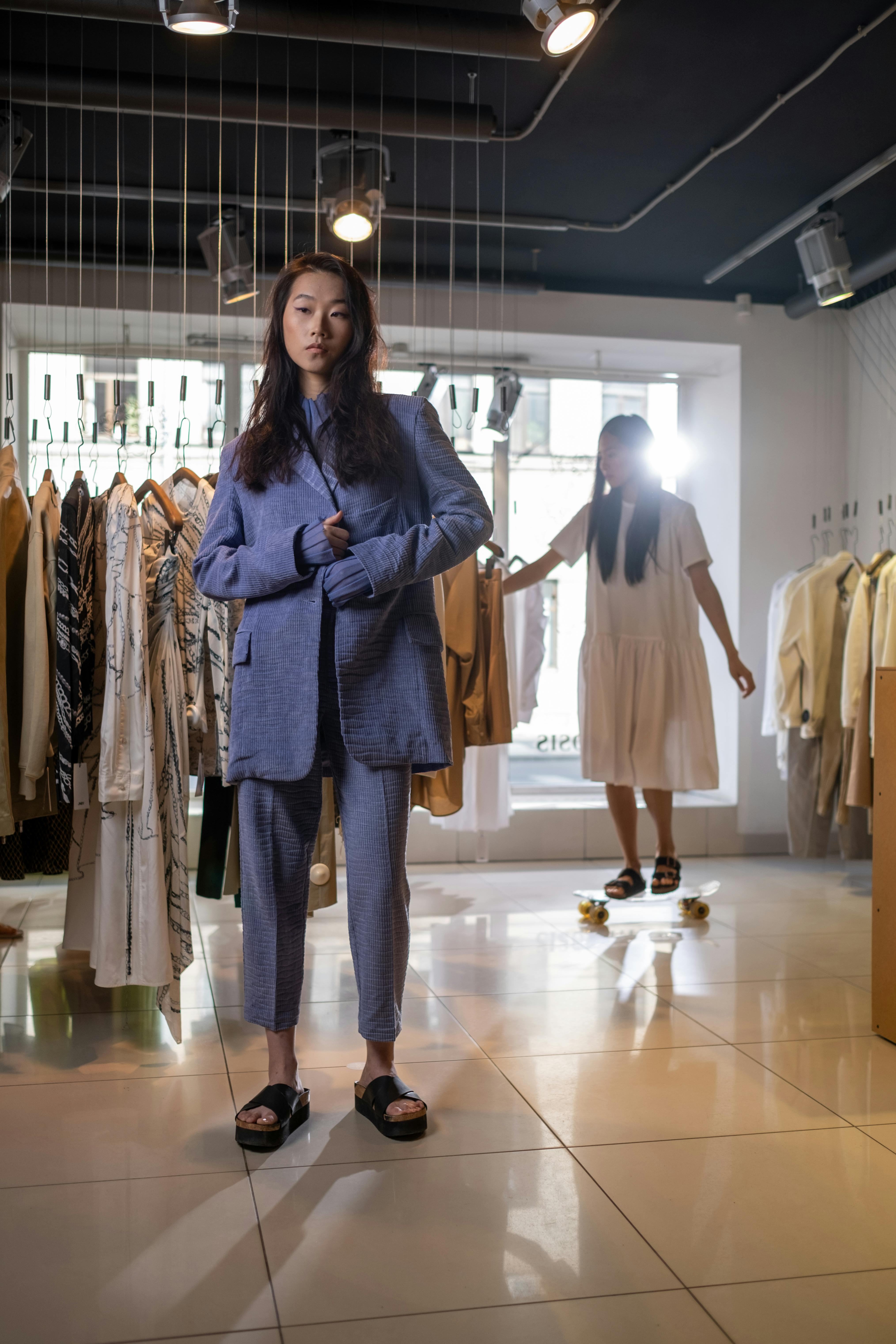 a stylish young woman standing in a boutique