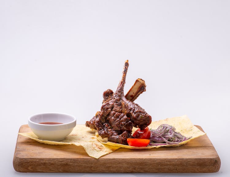 Grilled Lamb Chop With Sauce On Wooden Board