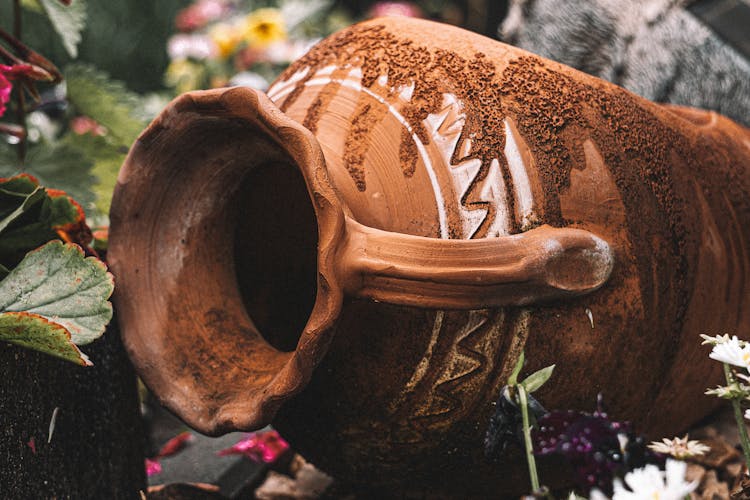 Antique Clay Jug In Garden