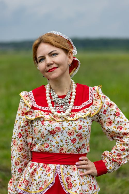 Woman in Yellow and Red Floral Long Sleeve Dress