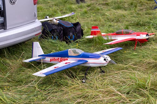 White Red and Blue Plane Toy on Green Grass