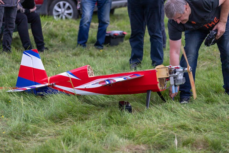 A Person Setting Up An RC Plane