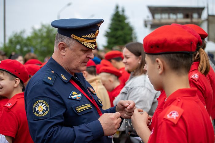 Military mentor speaking with young cadets