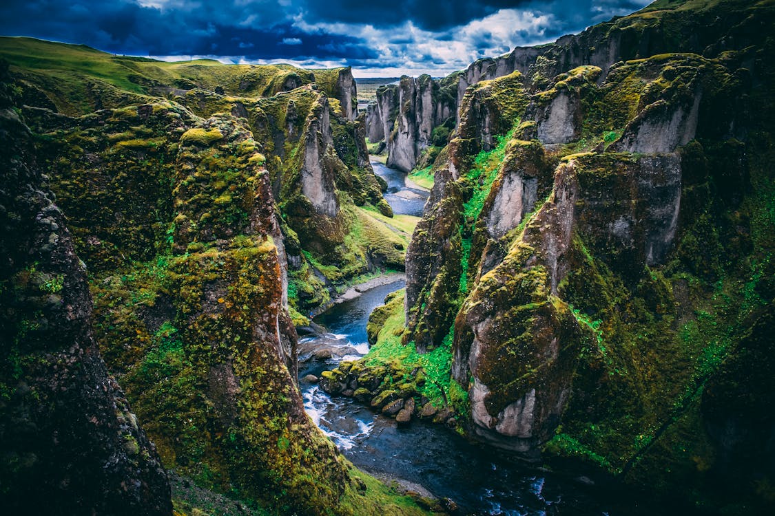 Photography Of Mountains Under Cloudy Skies