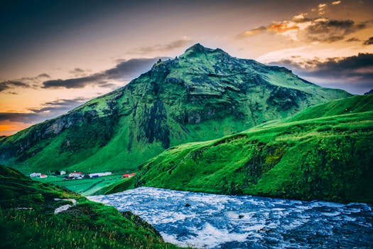 Experience the serene beauty of Iceland's mountains and rivers at sunset, offering a stunning natural landscape.