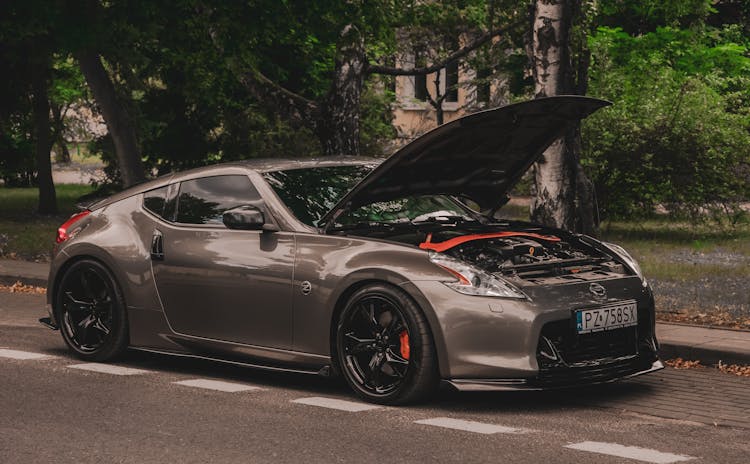 A Nissan Coupe Model Z With A Open Hood