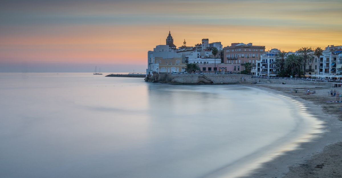 Beautiful twilight view of Sitges beach and cityscape in Catalonia, Spain.