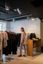A Woman Looking Clothes on the Shop