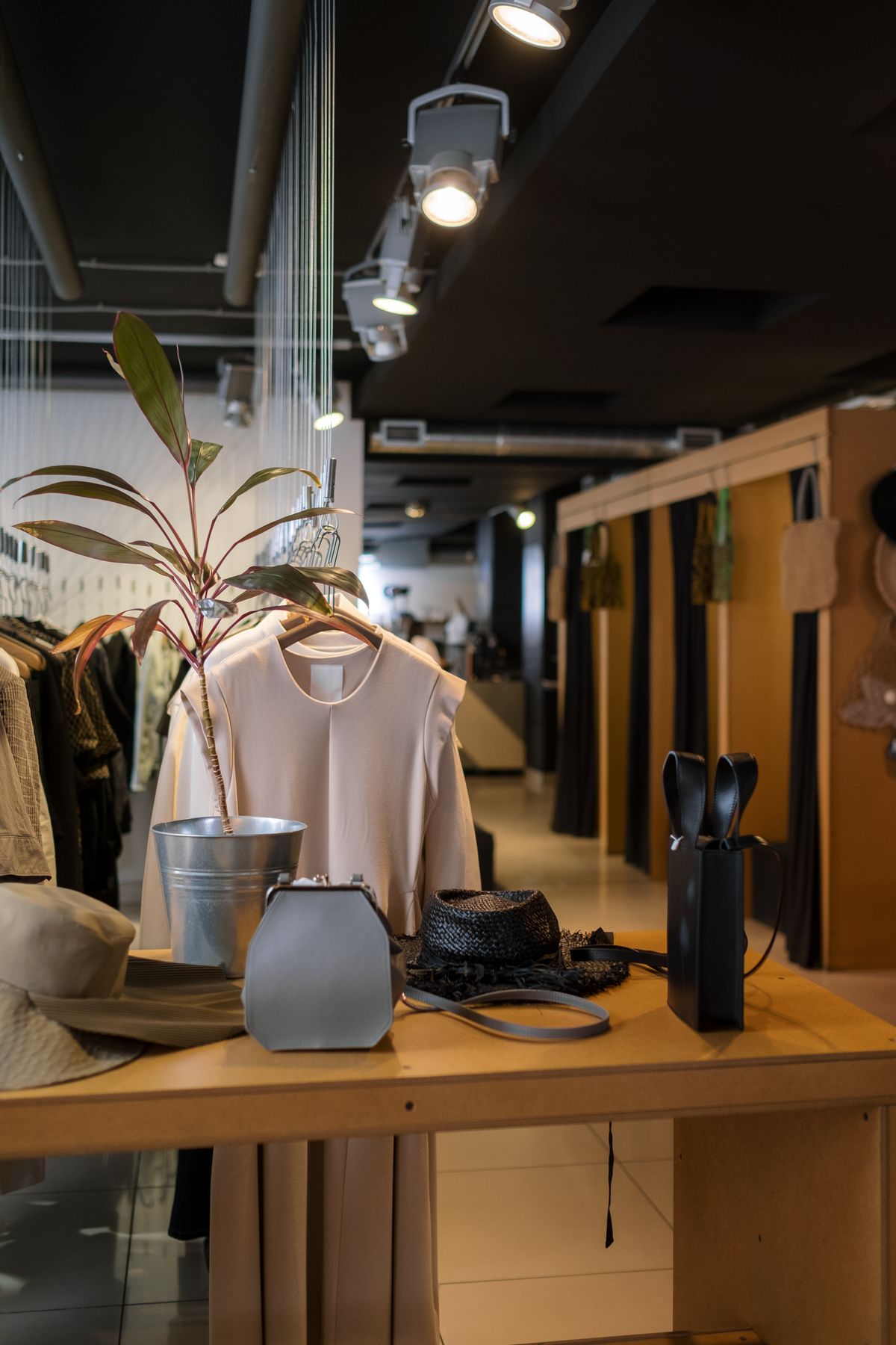 Organized clothing retail shop interior with product display racks
