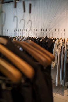 A trendy clothing rack with hanging garments in a fashion boutique, offering a sleek shopping experience.