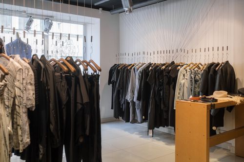 Free Modern clothing store showcasing a variety of garments on hangers. Stock Photo