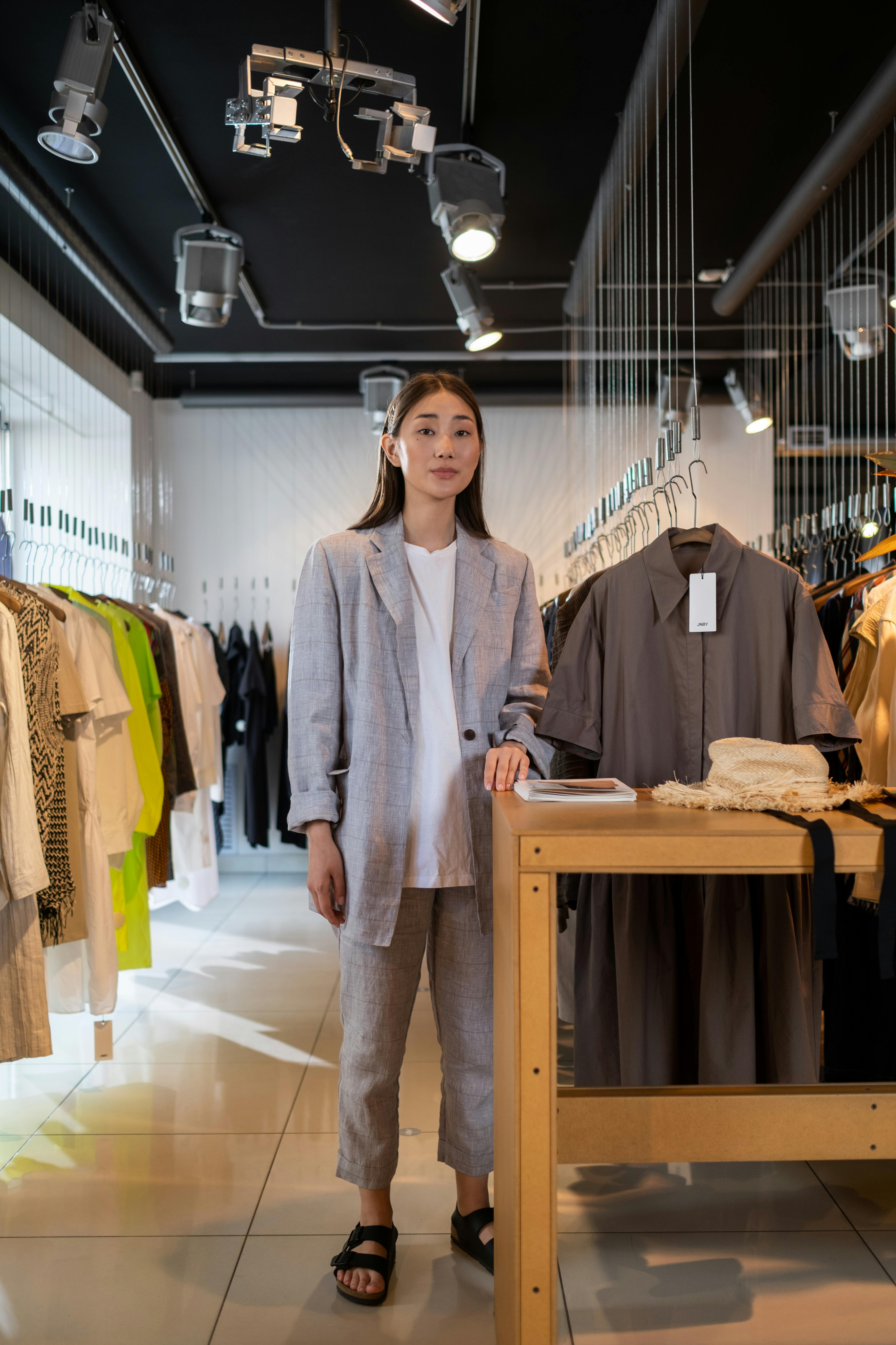 Woman Standing Inside the Clothing Shop · Free Stock Photo