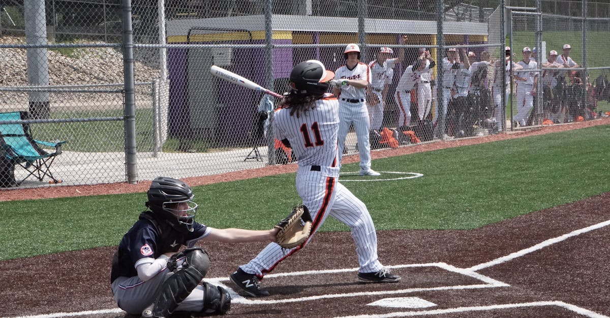 A dynamic scene of a baseball game with a batter swinging at the ball while the catcher is ready. Perfect sports shot.