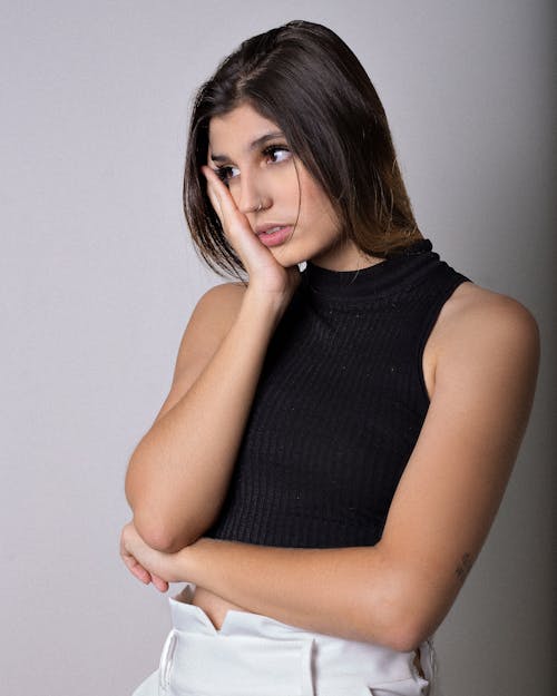 Close-Up Shot of an Attractive Woman in Black Sleeveless Crop Top Posing