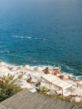 Relaxing beachfront scene with umbrellas in Antalya, a perfect vacation spot.