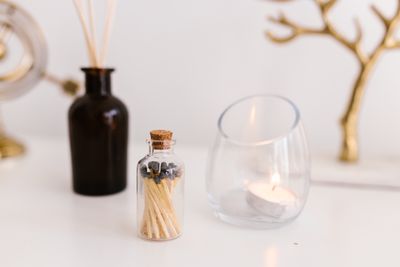 Cork-stoppered apothecary jar of matches beside a tealight — photo by RDNE Stock project on Pexels
