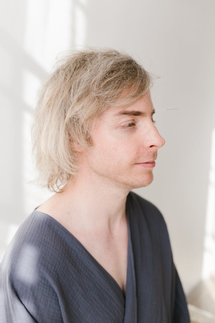 Close-Up Shot Of A Man With A Needle On His Face