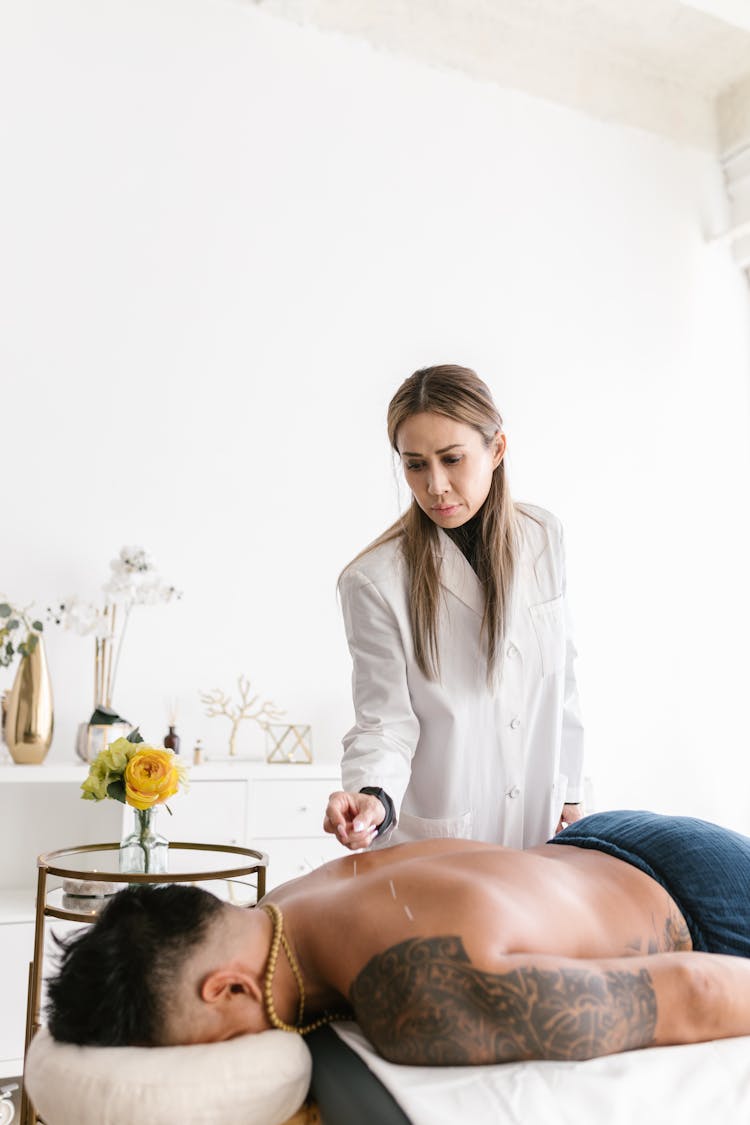 A Woman Doing Acupuncture On A Client