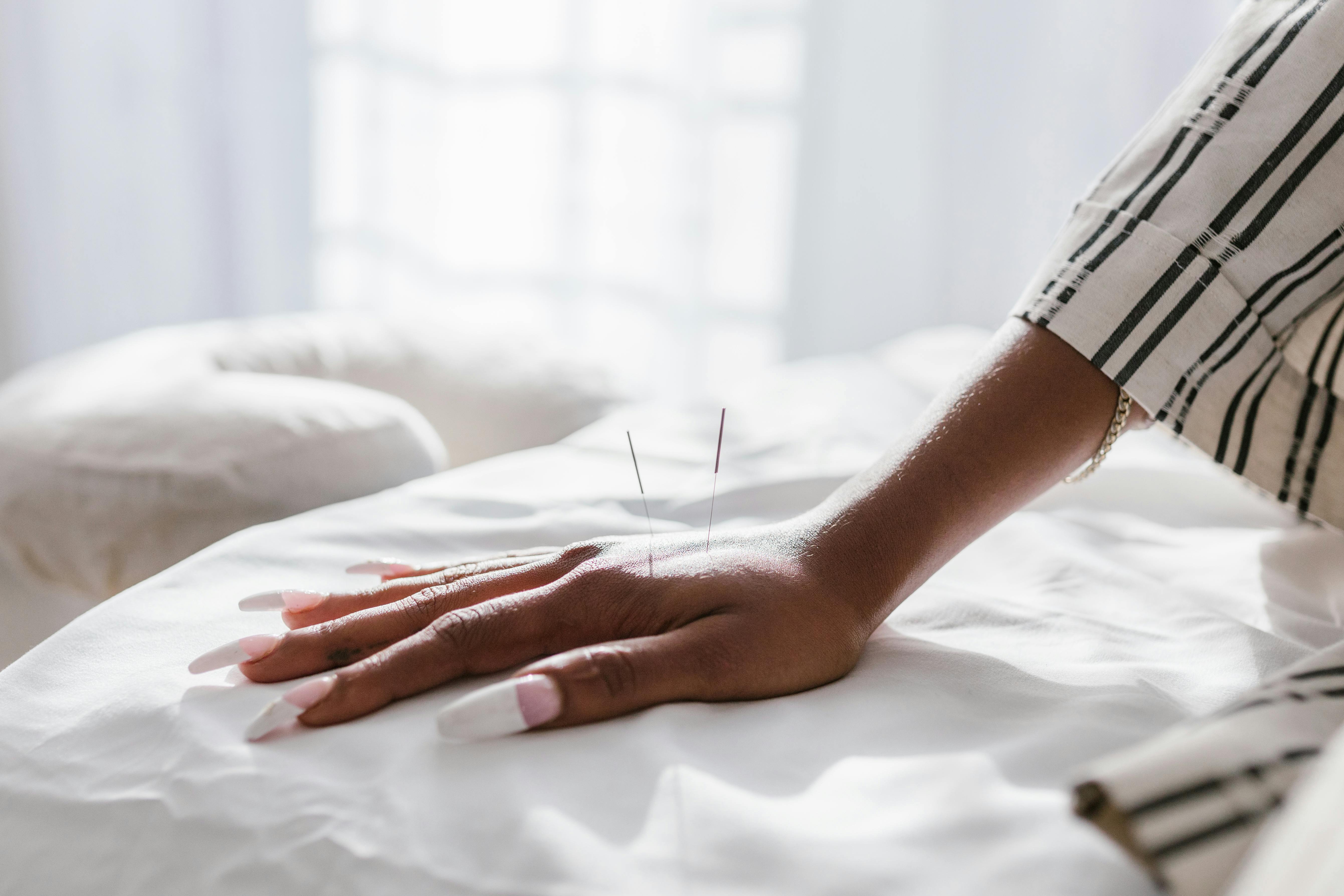 close up shot of a person with a needle on her hand