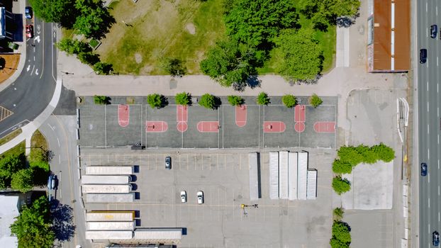 Aerial shot of urban basketball courts, streets, and greenery.