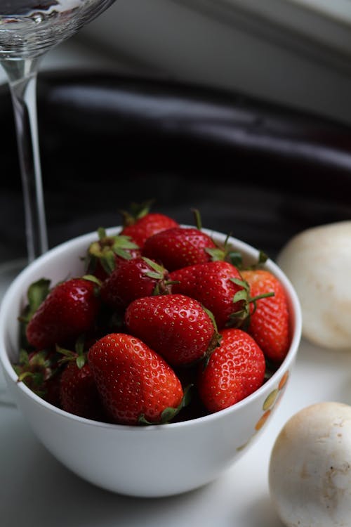 A Fresh Strawberries on a White Ceramic Bowl