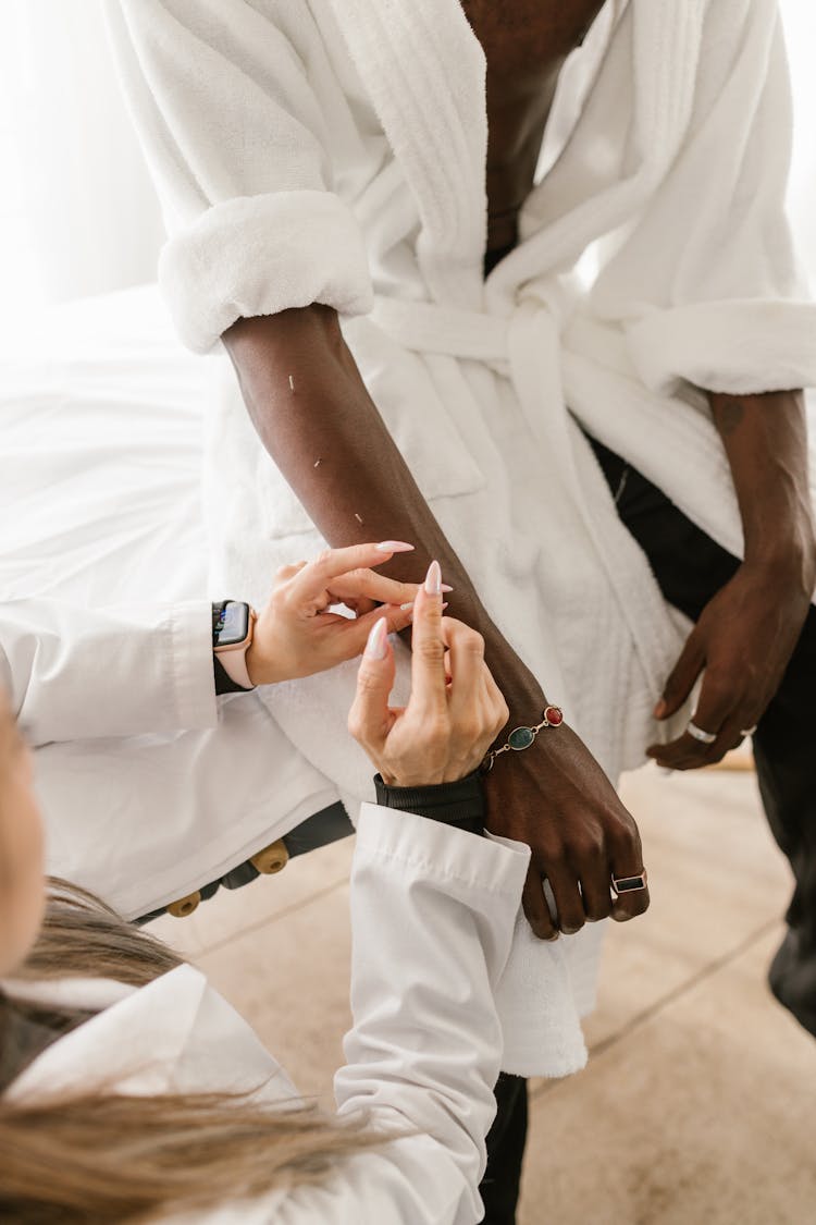 A Doctor Putting Needles On A Man's Arm