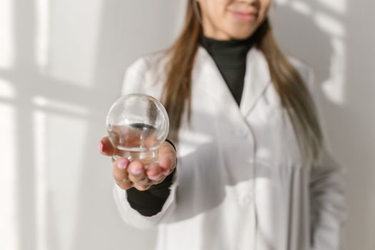 A Therapist Holding a Glass Suction