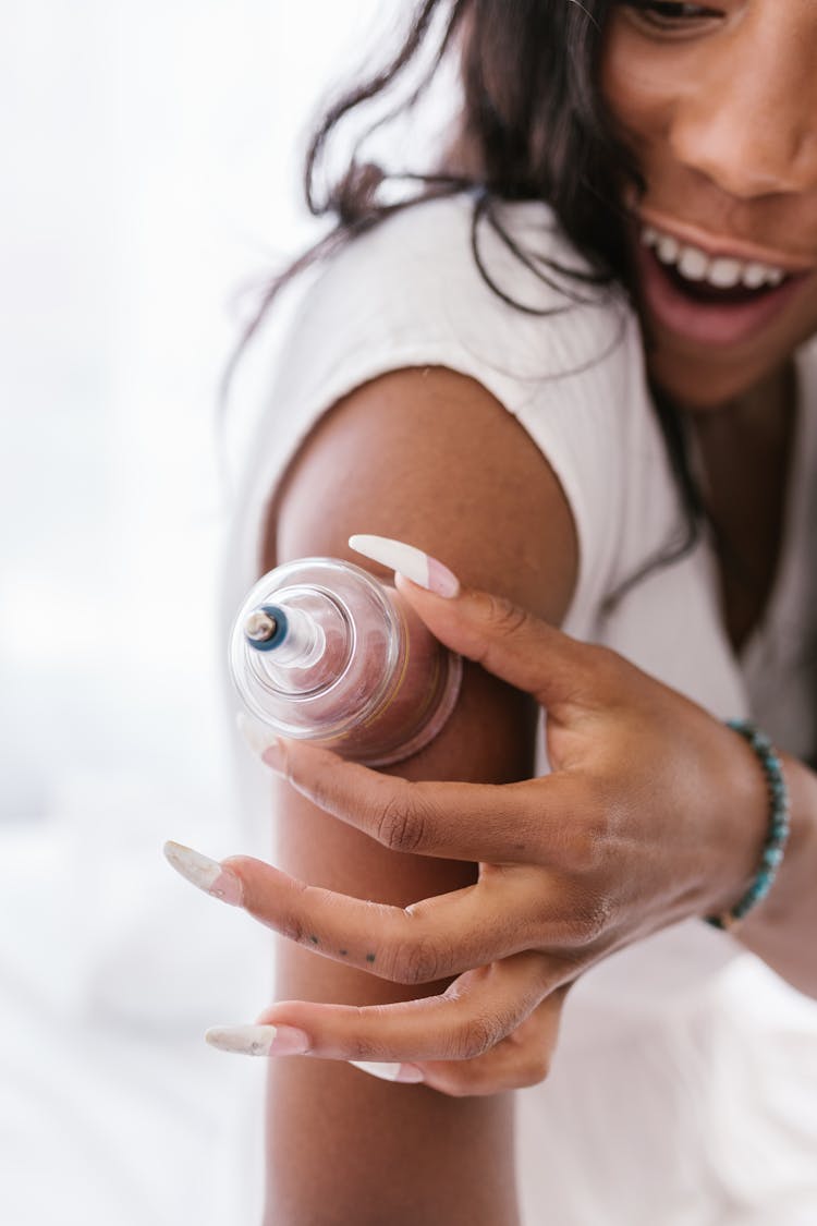 A Woman With A Suction Glass On Her Shoulder