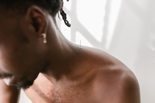 Free Close-Up Shot of a Man with a Needle on His Shoulder Stock Photo