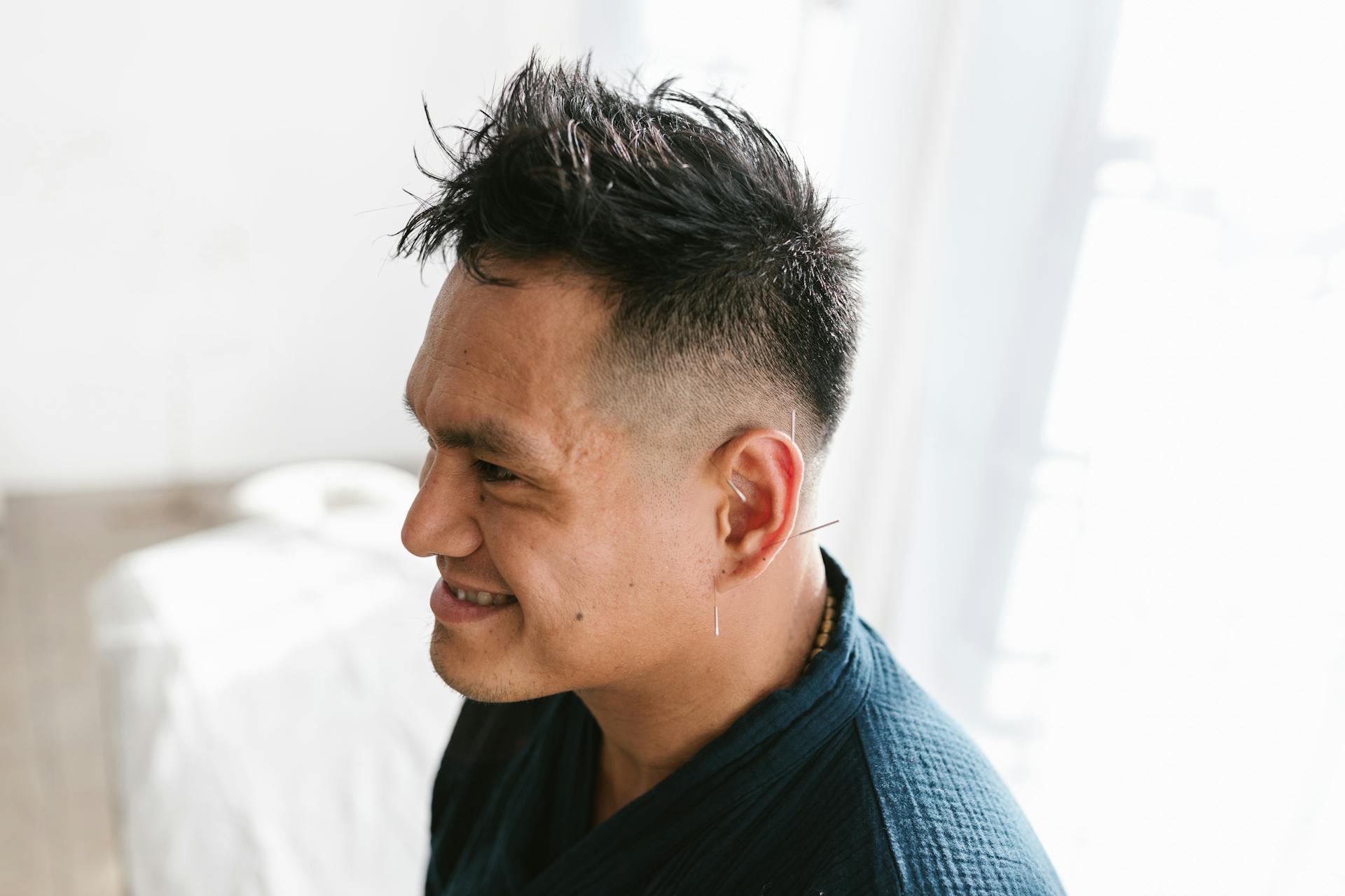 A Man with Needles on His Ear