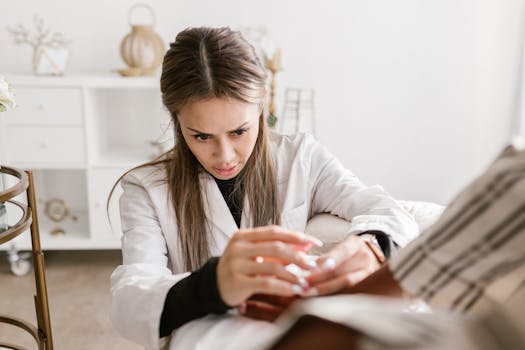 A concentrated female doctor providing medical care to a patient in a professional setting. Ideal for health and medical themes.