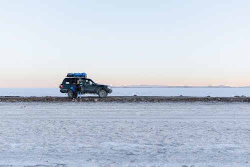People with SUV on Frozen Plains in Winter