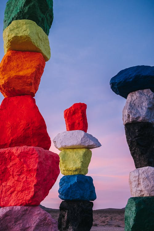 Red Blue Green and Yellow Rocks Under Blue Sky