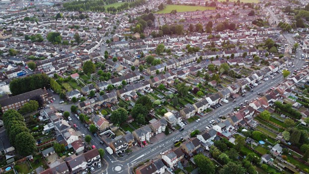 Aerial view showcasing a suburban residential area in Luton, England with houses and greenery.