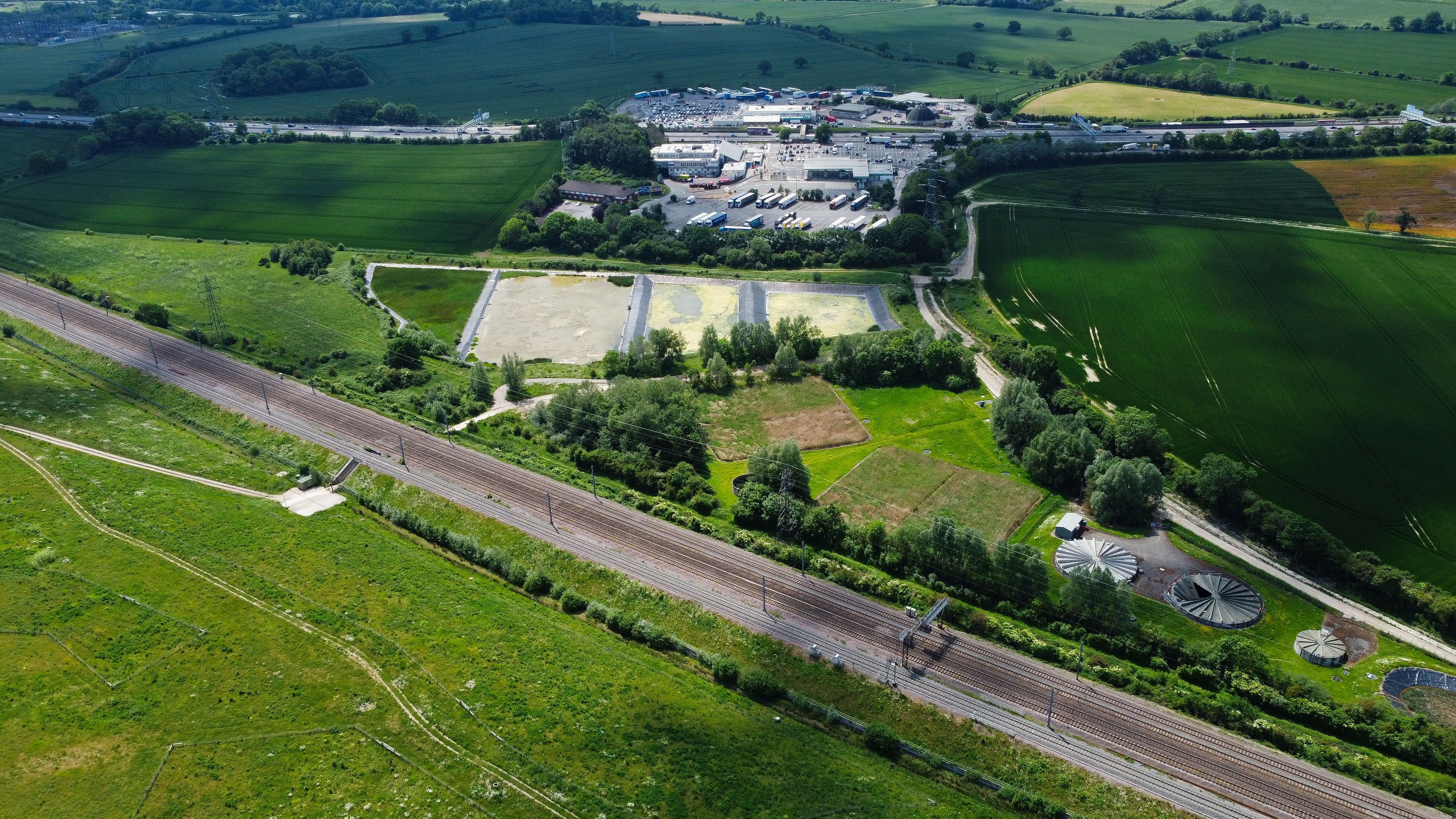 Unbeatable 25 Minute Helicopter Discovery Trial Lesson Review: Your Gateway to Flying Over England Review 2026 - Aerial view showcasing vast fields, railways, and industrial area in Harlington, UK.