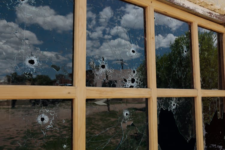 A Window With Bullet Holes