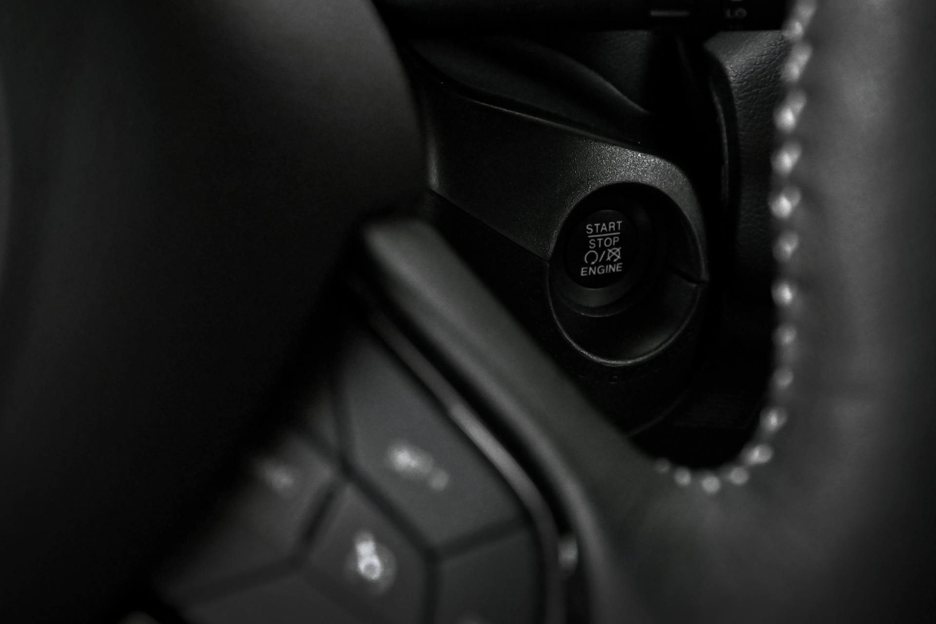 Detailed view of a car's ignition start stop button for seamless engine control.