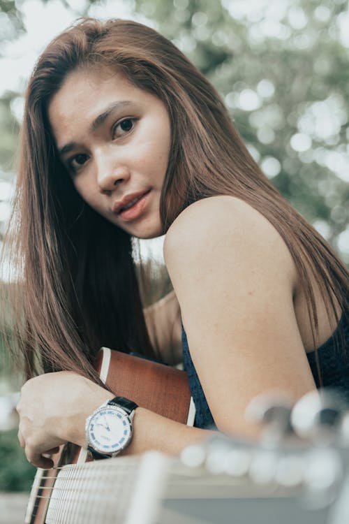 Close-Up Shot of a Pretty Woman Looking at Camera