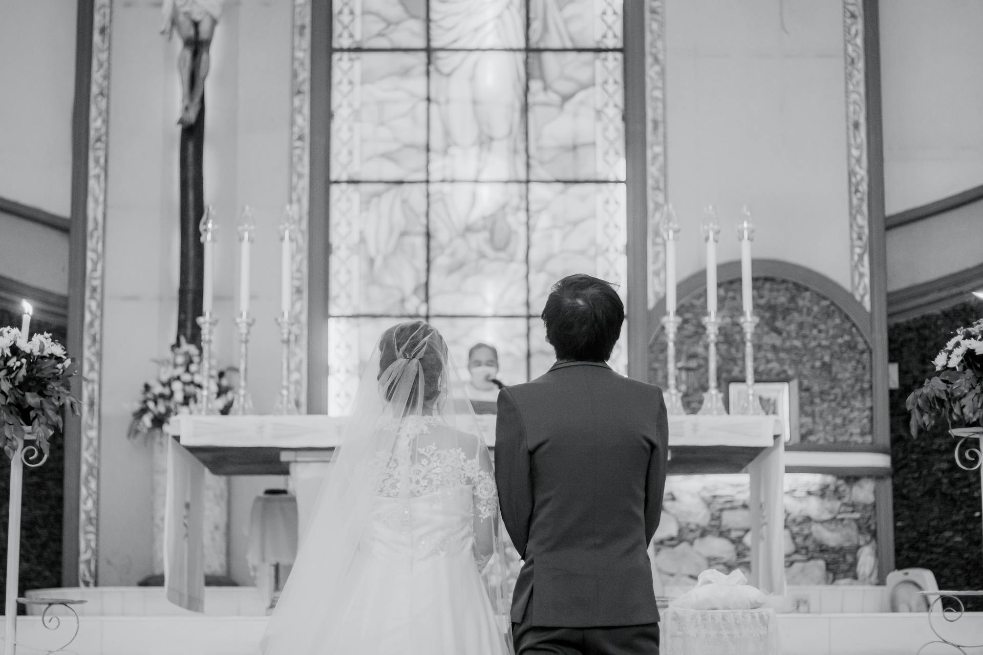 A couple standing at the altar during a traditional church wedding ceremony.