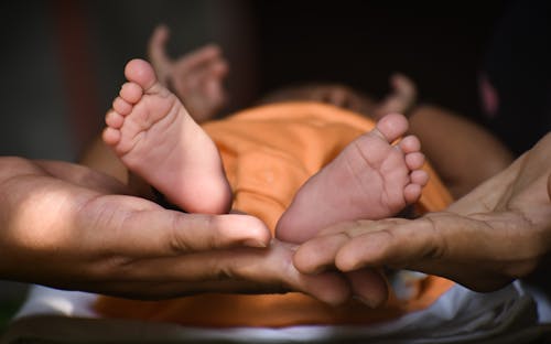 Free Person Holding Babys Feet Stock Photo