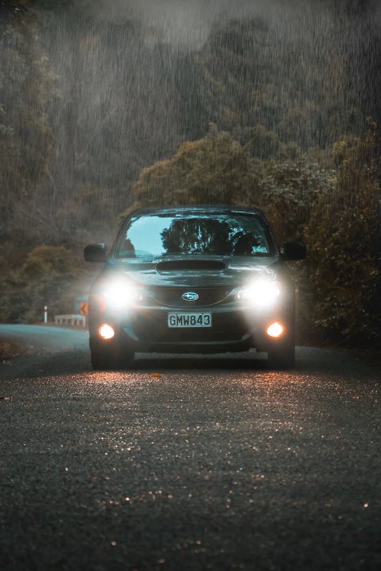 A Moving Car On The Road While Raining