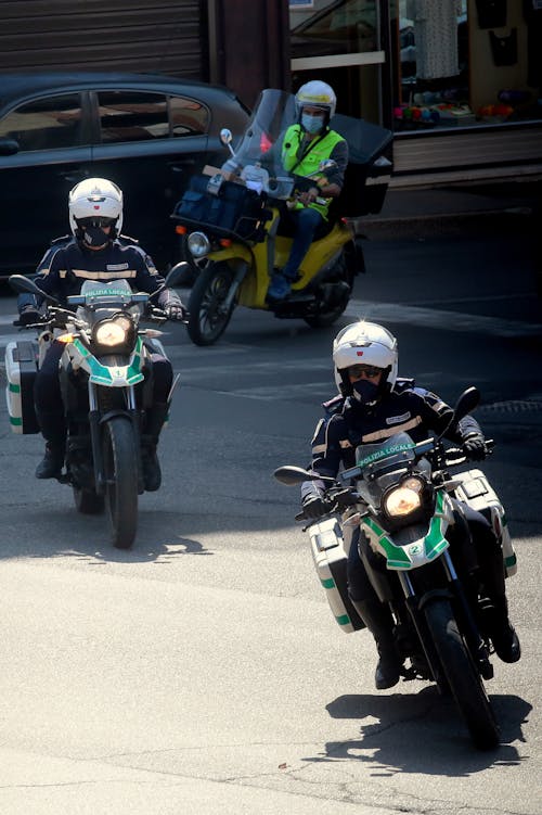 Free A Group of People Riding a Motorcycle on the Road Stock Photo