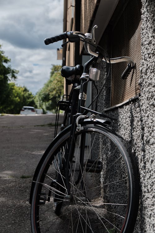 A Black Bike Leaning on a Wall