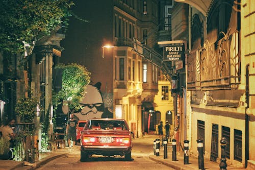 Free A Red Car Moving on the Street at Night Stock Photo