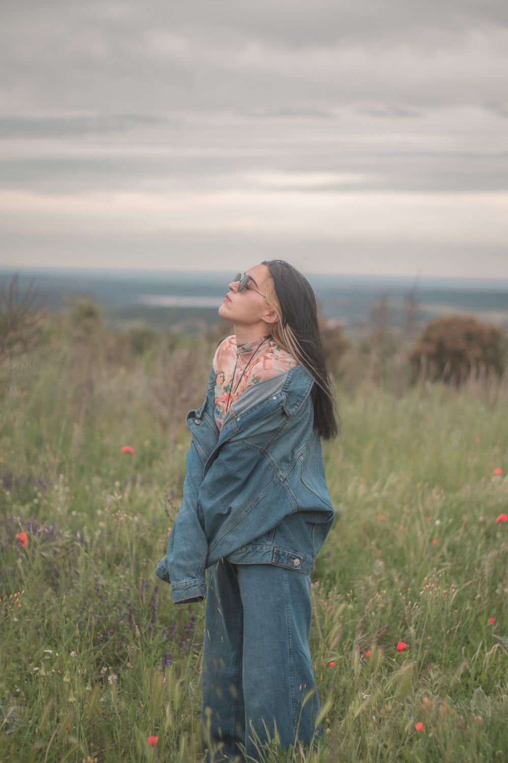 A Woman in Denim Jacket and Pants Standing on Green Grass Field · Free ...