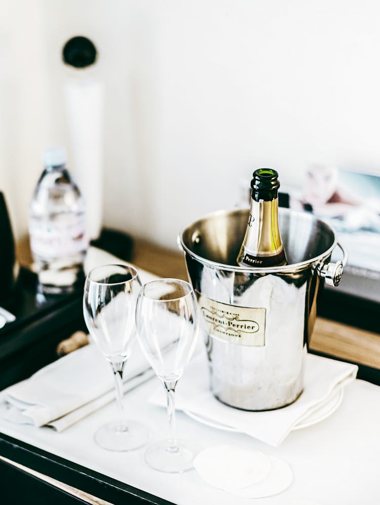 A Champagne Bottle In An Ice Bucket